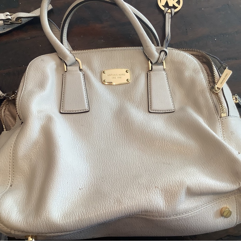 Michael Kors cream purse with padded pocket inside for electronics.